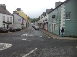 Glenarm High Street with Jim loitering next to a pub. The only two pubs are next to each other!
